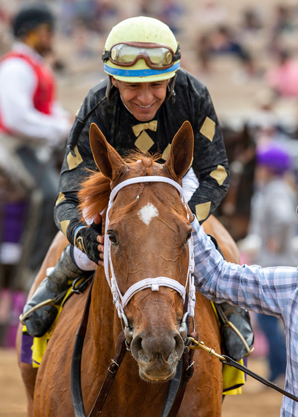 Triple Crown winning jockey Victor Espinoza waves to the crowd before  throwing out the ceremonial first pitch before the baseball game between  the Arizona Diamondbacks and San Diego Padres in a baseball